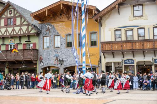 a group of people in a parade in front of a crowd at River Heights Home cabin in Leavenworth