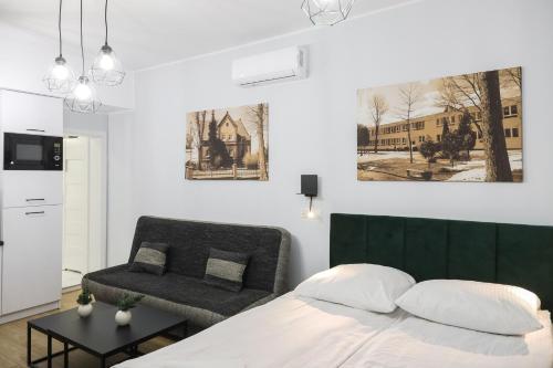 Apartamenty Różane في Laski: غرفة نوم بسرير وكرسي