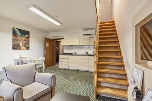 a living room with a staircase and a kitchen at Excellent apartments in Karlovy Vary in Karlovy Vary