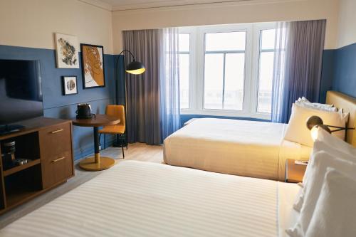 a hotel room with two beds and a television at Hotel Julian in San Francisco
