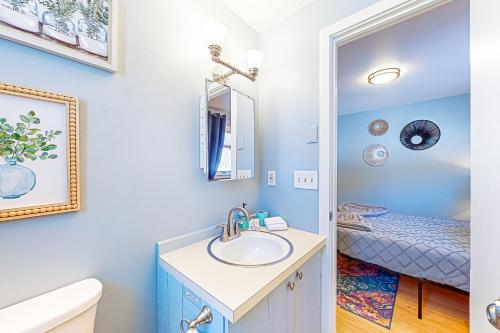 a bathroom with a sink and a mirror at Sugarbush Ski Getaway - Lower in Warren