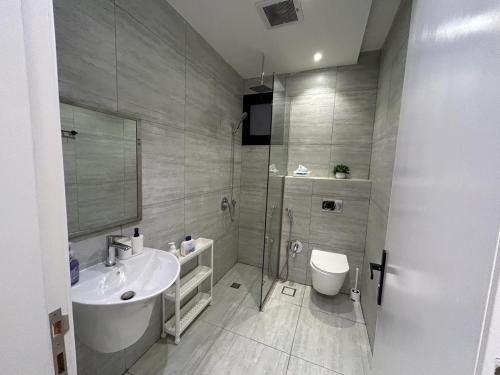 a bathroom with a sink and a toilet at Smart luxury apartment 3bedrooms in Riyadh