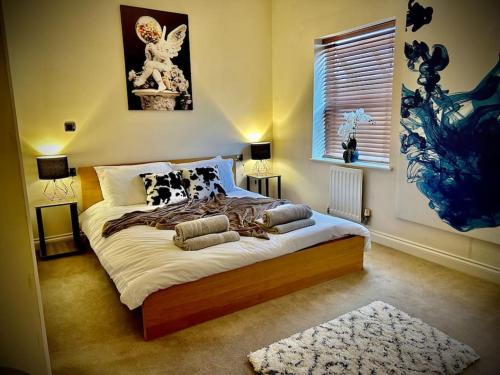 a bedroom with a large bed with pillows on it at 5 Bedroom House-Sleeps 13-Big Savings On Long Stays! in Colchester