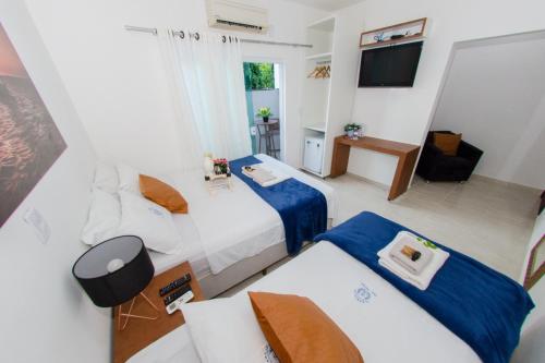 En eller flere senge i et værelse på Pousada Dom Marujo