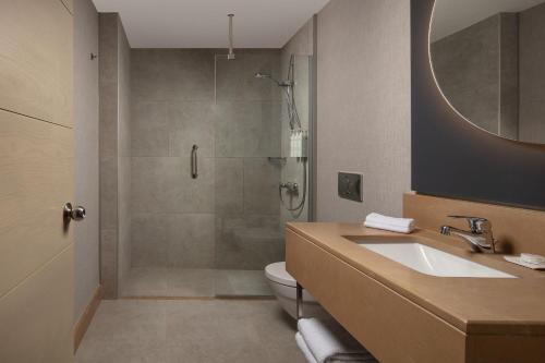 a bathroom with a shower and a sink and a toilet at Delta Hotels Istanbul West in Istanbul