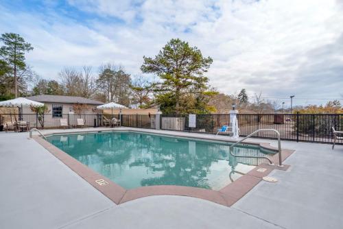 a swimming pool in a yard with a fence at Best Western Andalusia Inn in Andalusia