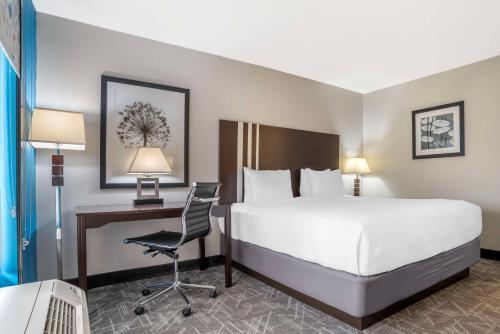 a hotel room with a bed and a desk with a computer at Best Western Andalusia Inn in Andalusia