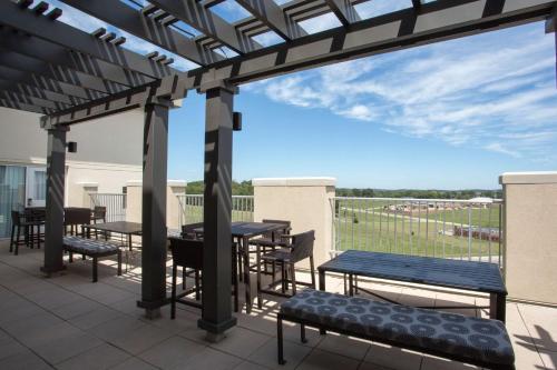 a patio with tables and chairs on a roof at Drury Plaza Hotel Cape Girardeau Conference Center in Cape Girardeau