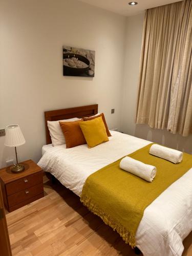 a bedroom with a bed with two pillows on it at Britain in the Sun at Luxurious Ocean Village in Gibraltar