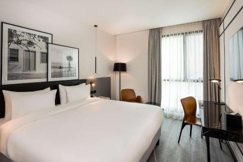 a large white bed in a hotel room at Radisson Hotel Tunis, City Center in Tunis