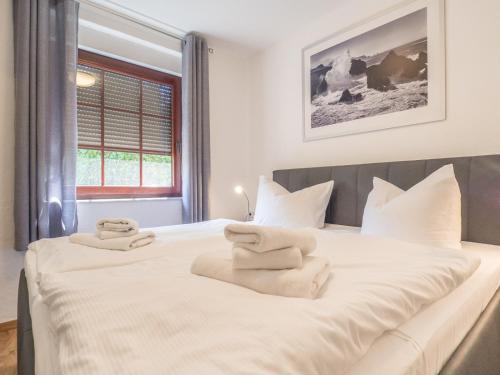 una camera da letto con un grande letto bianco con asciugamani di Ferienhaus Vesteralen a Breege