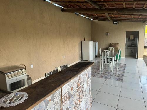 a kitchen with a counter top and a refrigerator at Cantinho da Alegria in Raul Soares