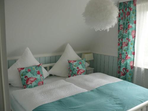 a bedroom with a bed with pillows and a window at Wik7B in Niendorf