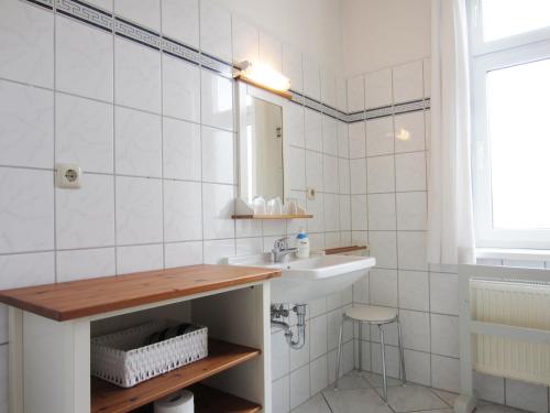 a bathroom with a sink and a mirror at Ferienwohnung Am Molli Nr. 2 in Kühlungsborn