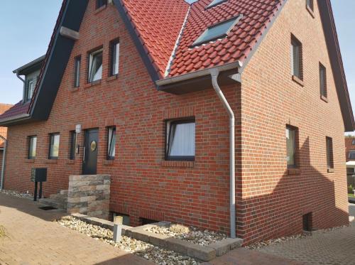 a red brick house with a red roof at StrandinSicht in Norderney