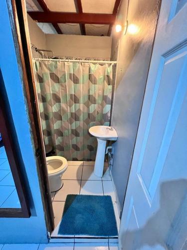 a small bathroom with a toilet and a sink at Hotel Pacific Surf with AC Best Room In Tunco Beach in Tamanique