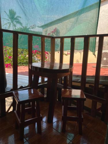 a table and two stools on a balcony with a view at Hotel Pacific Surf with AC Best Room In Tunco Beach in Tamanique