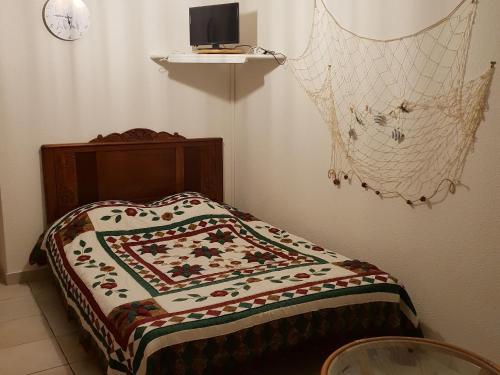 Bett mit einer Decke auf dem Zimmer in der Unterkunft Gîte La Turballe, 1 pièce, 2 personnes - FR-1-306-901 in La Turballe