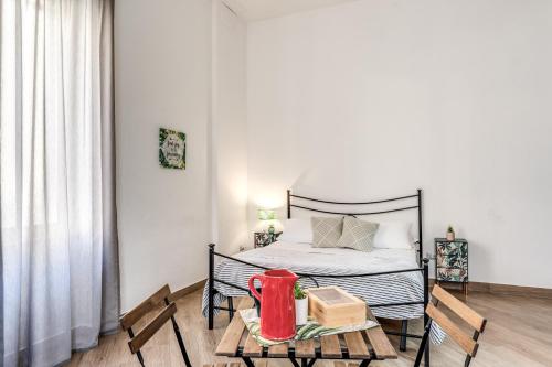 um quarto com uma cama, uma mesa e cadeiras em Le Mura Antiche em Nápoles