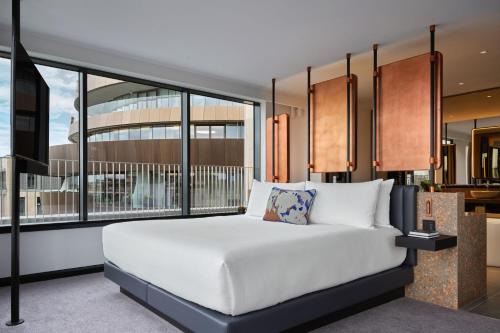 a bedroom with a bed and a large window at W Edinburgh in Edinburgh