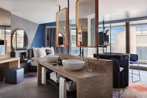a hotel room with two sinks and a bathroom at W Edinburgh in Edinburgh
