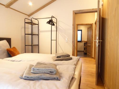two beds in a room with towels on them at Chalet Pearl Winterberg Modern Wifi 6 Personen near by Bikepark in Winterberg