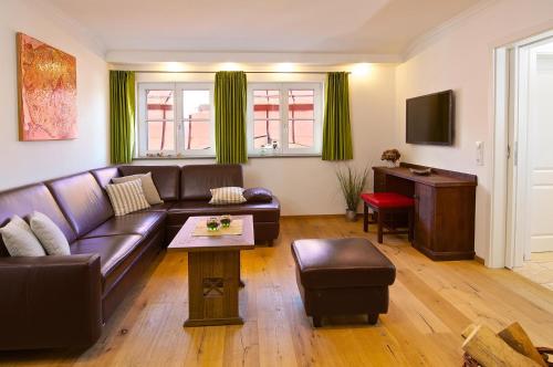 a living room with a couch and a table at Alpenblick in Oberstaufen