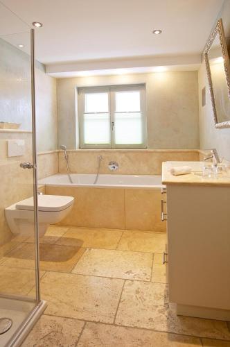 a bathroom with a tub and a toilet and a sink at Hochgrat in Oberstaufen