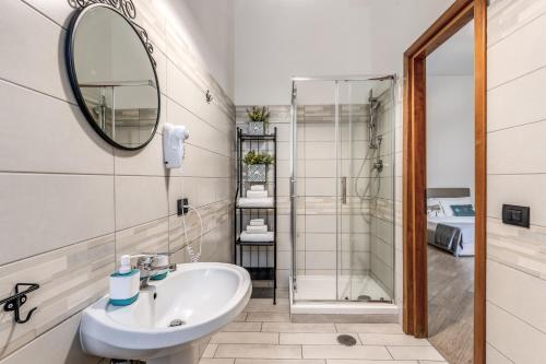 a bathroom with a sink and a shower at Le Mura Antiche in Naples