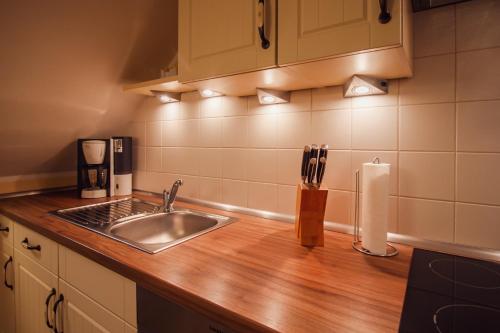 a kitchen with a sink and a counter top at Int Hörn 8 OG in Krummhörn