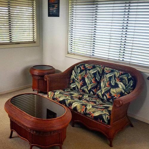 a living room with a couch and a table at Hale Hualalai in Kailua-Kona