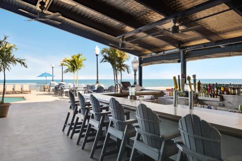a bar with chairs and a view of the beach at Holiday Inn & Suites Ocean City by IHG in Ocean City