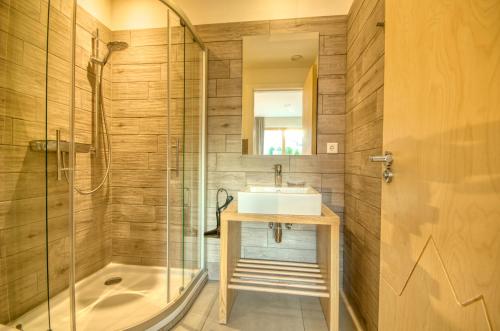 a bathroom with a sink and a shower at Gletscherblick 1 - by Alpen Apartments in Zell am See
