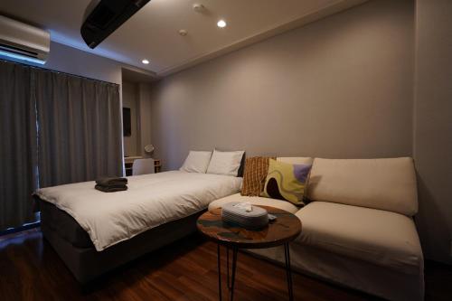 Pokój z 2 łóżkami i kanapą w obiekcie Penthouse 1-bedroom flat in Hiroo Shibuya w Tokio