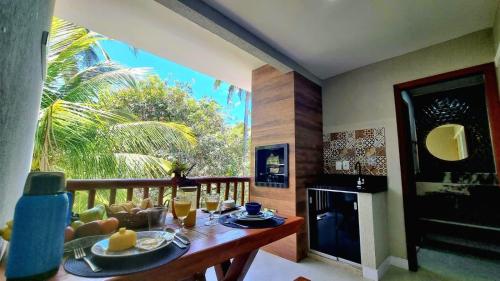 マタ・デ・サン・ジョアンにあるApê Varanda Gourmet Wi-fi 300mbs Garagem Arcondiconado Cozinha completa Streamingのダイニングルーム(テーブル、食べ物付)
