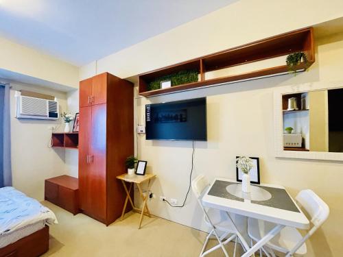 a small room with a table and a bed at City View Studio Unit at Aspira Tower 1 in Cagayan de Oro
