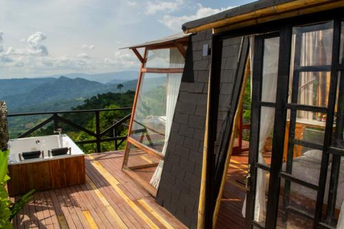 a house with a view of the mountains at NaturalMente Glamping in San Antonio del Tequendama