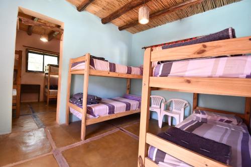 a room with bunk beds in a house at Tilcara Rustica Hostel in Tilcara