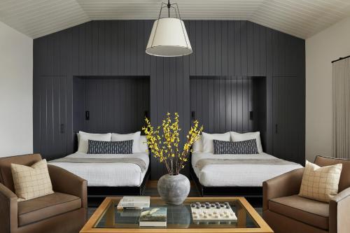 a living room with two beds and a table at The Lodge at Bodega Bay in Bodega Bay