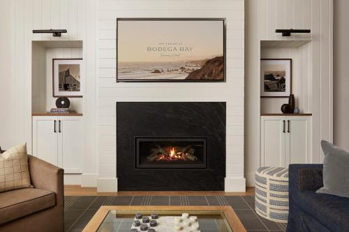 a living room with a fireplace and a couch at The Lodge at Bodega Bay in Bodega Bay