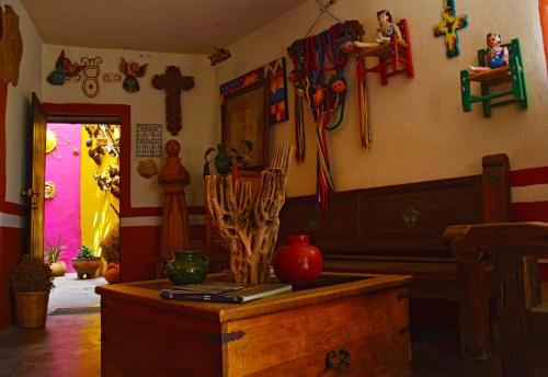 a room with a table and some items on the wall at Posada del Fraile in Tepotzotlán