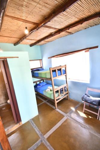 a room with two bunk beds and a chair at Tilcara Rustica Hostel in Tilcara