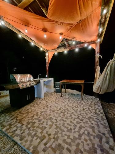 a tent with a table and a bench in a room at Pinilla Highlands Incredible mountain views in Tamarindo