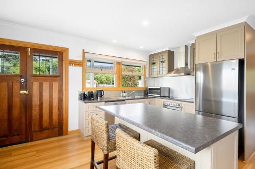 a kitchen with a stainless steel refrigerator and cabinets at LuCo House Stanley in Stanley
