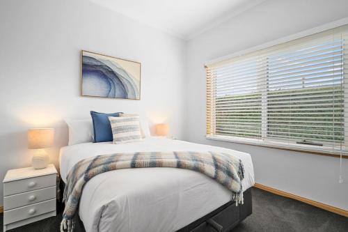 a bedroom with a large bed and a window at LuCo House Stanley in Stanley