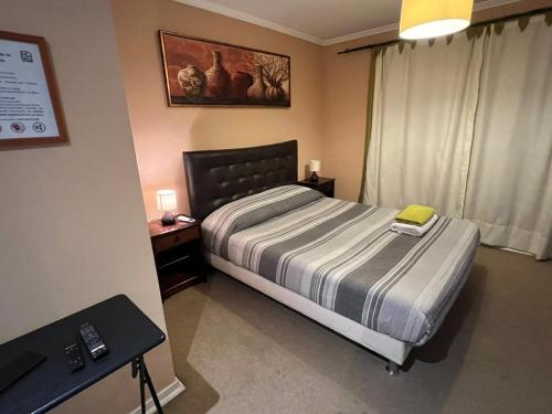 1 Schlafzimmer mit einem Bett und einem Schreibtisch sowie einem Bett der Marke sidx sidx sidx. in der Unterkunft Machali Casa HOSTAL Habitación con Baño Privado y estacionamiento in La Viñilla