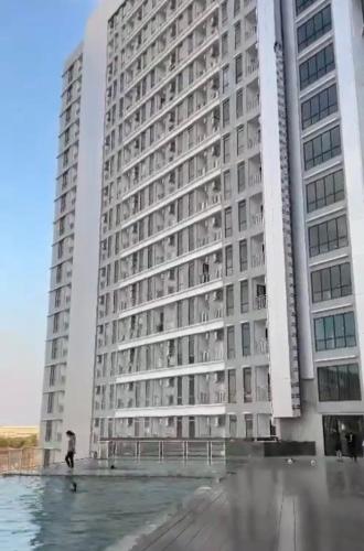 a tall building with a person standing in front of it at Delft Apartment - Sea View Studio Flat at Losari Beach in Makassar