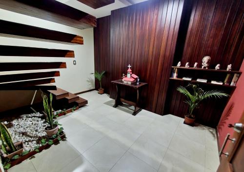 a living room with a table and plants in it at Beautiful view suite Suite vista hermosa in Macas