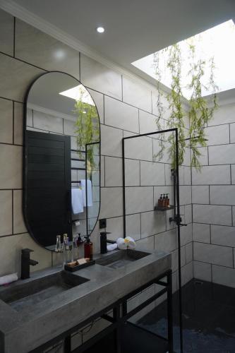 a bathroom with a sink and a mirror at A Private 3-Bedroom Villa in Legian, Bali in Legian