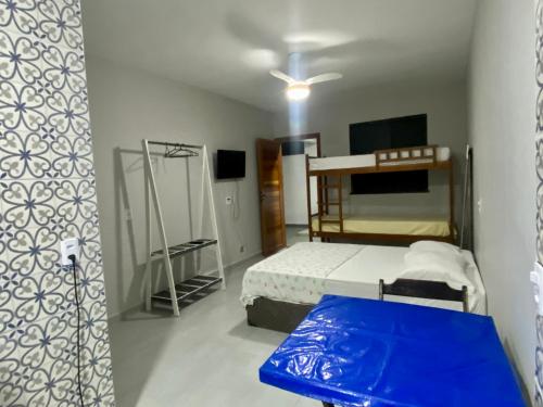 a bedroom with a bunk bed and a blue mattress at Âncora Lofts in Arraial do Cabo